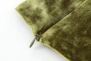 Macro shot of grass green velvet fabric featuring a matching invisible zipper closure