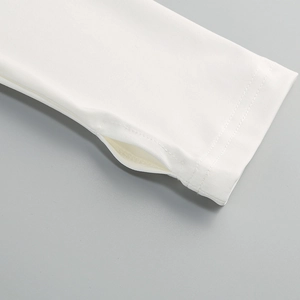 Detail of white long sleeve dress showing elastic cuff with a functional thumbhole