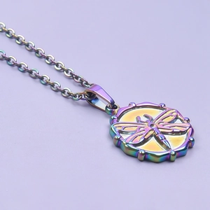 Macro shot of stainless steel necklace with iridescent dragonfly pendant on purple background