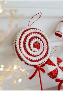 Macro view of red and white glitter candy lollipop ornament with velvet bow for Christmas tree