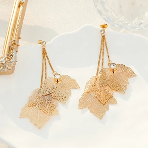 Elegant gold hollow leaf earrings with sparkling rhinestone tassels for a chic look