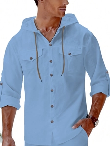 Detail of sky blue linen hooded shirt featuring chest pockets and drawstring hood