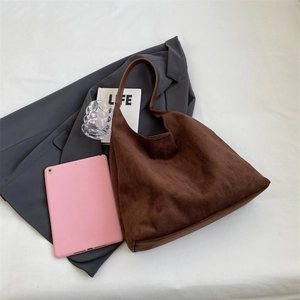 Detail of soft brown suede tote bag with spacious interior and minimalist shoulder strap