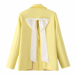 Vibrant yellow satin blazer with a large white decorative bow on the open back