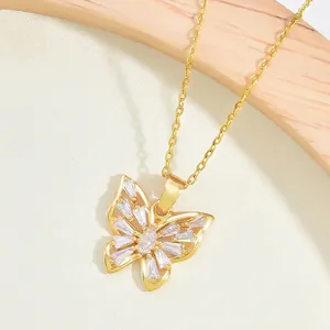Elegant gold butterfly necklace with sparkling zircon wings on a minimalist background