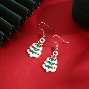 Detail of enamel Christmas tree earrings with red star topper and green festive waves