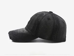Close-up of washed denim baseball cap featuring vintage distressed edges and worn details