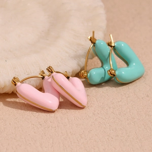 Detail of pink and mint green heart earrings with 18K gold plated stainless steel edges