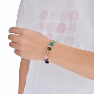 Detail of beaded zodiac bracelet featuring mixed natural crystals and constellation charm