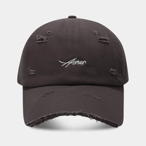 Detail of distressed baseball cap with Asher embroidery and vintage frayed brim edges