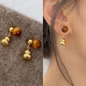 Silver needle tiger eye gourd earrings in geometric design for women on a sweater and model
