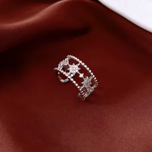 Luxurious double-layer hollow ring with zircon stars on dark red silk background