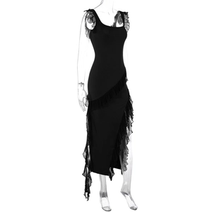 Detail of black slim fit dress featuring diagonal ruffle trim and asymmetric slit hemline