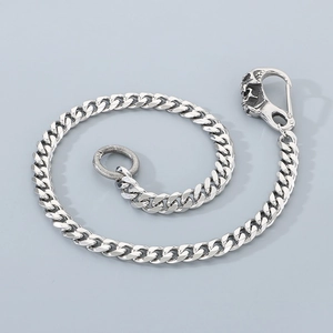 Detail of silver cuban link pants chain with skull spring clasp and circular metal ring