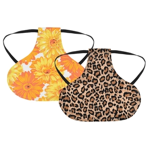 Detail view of printed poultry hen saddle protectors with yellow floral and leopard patterns