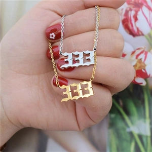 Detail of gothic number 666 pendants on gold and silver stainless steel chain necklaces