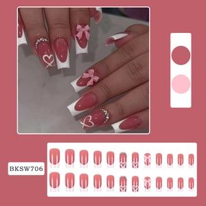 Deep pink bow and heart press-on nails with rhinestones and long coffin shape