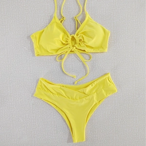 Yellow halter bikini set with ring detail and high-waisted V-cut swim bottom