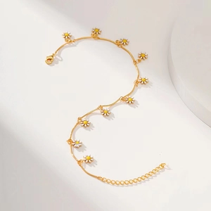 Detail of gold daisy chain necklace with white enamel petals and adjustable extension link