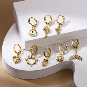 Golden stud earring set with zircon motifs like eye, heart, and fish tail charms