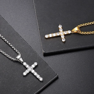 Macro detail of gold and silver hip-hop cross pendants with micro-pave cubic zirconia