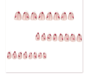 Detailed flat lay of strawberry pattern press-on nails in sweet almond shape style