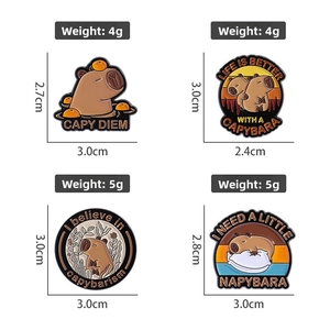 Detailed view of four capybara enamel pins with Capy Diem text on white background