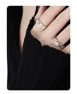 Close-up of S925 sterling silver rings with textured wavy bands and sparkling diamonds