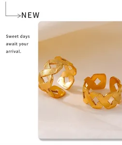 Detail of gold 18k plated braided twist open ring with brushed metal texture for women
