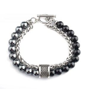 Detail of bohemian layered bracelet with black beads, woven chain and vintage T-bar clasp