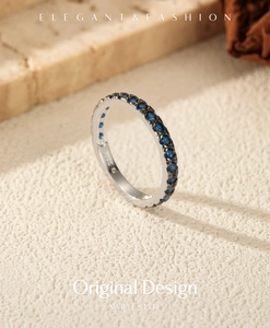 Macro detail of S925 sterling silver stamp and blue cubic zirconia stones on ring