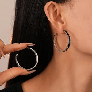 Minimalist silver hoop earrings with black zircon pavé for a luxury aesthetic style