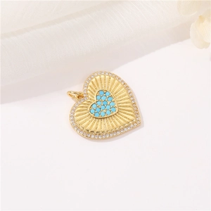 Close-up of gold heart pendant with turquoise center and micro-paved cubic zirconia