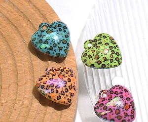Detail of leopard print heart charms in blue green orange and pink with UV finish
