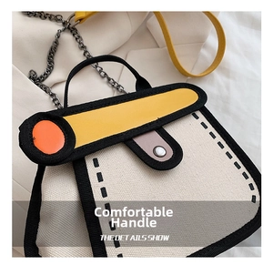 Detail showing 2D comic style canvas handbag with bold black outlines and metal chain strap