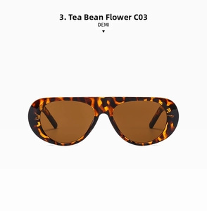Detail of oversized sunglasses in demi tortoise texture with brown translucent lenses