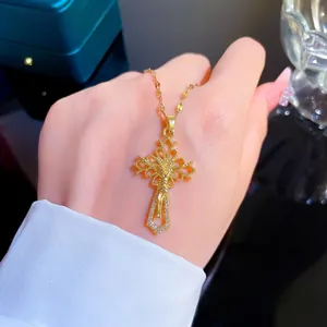 Detailed view of a gold titanium steel crucifix necklace with micro-set zircons on hand