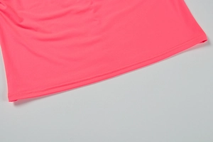 Detailed close-up of double-needle hem stitching on neon pink bodycon dress fabric