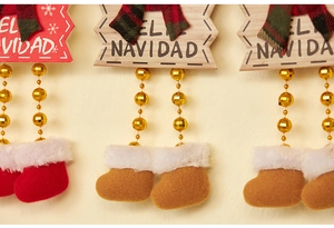 Detail of wooden Feliz Navidad hanging ornaments with bead legs and festive felt boots