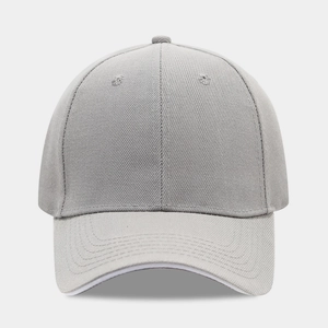 Close-up of a light grey cotton baseball cap showing twill texture and stitching