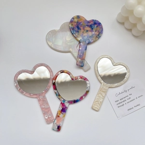 Vintage acetate heart-shaped hand mirrors in colorful marble patterns and pastel tones