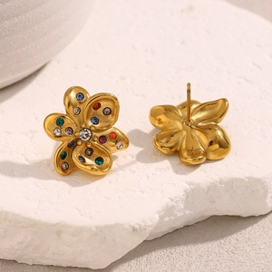 Detailed macro view of 18K gold floral stud earrings with multi-colored crystals