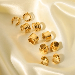 Set of five 18K gold-plated stainless steel ear cuffs on elegant yellow satin fabric
