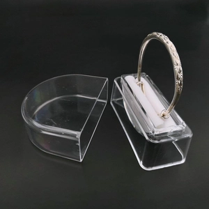 Detail view of transparent acrylic jewelry box with a silver textured bracelet