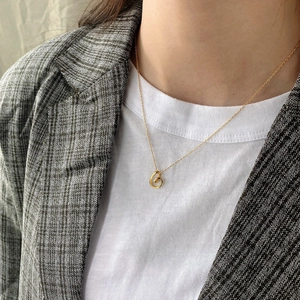 Elegant 925 sterling silver gold swirl pendant necklace shown on a professional model