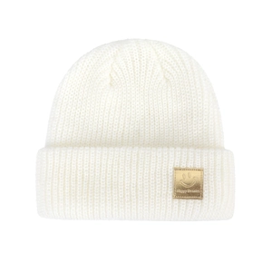 Detailed close-up of white knitted beanie featuring golden happy face logo patch