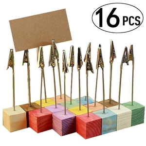 Close-up of 16 colorful wooden cube photo holders with metal alligator clips