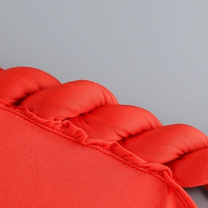 Close-up of red bodycon dress featuring detailed twisted knit texture and braided edges
