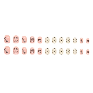 Short pink press-on nails featuring cute bunny drawings and love heart patterns
