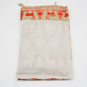 Linen Christmas drawstring gift bag with red reindeer and tree patterns on beige fabric